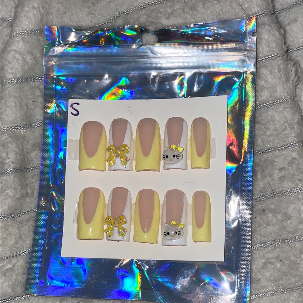 Yellow and white hello kitty French tip, homemade press on nails.